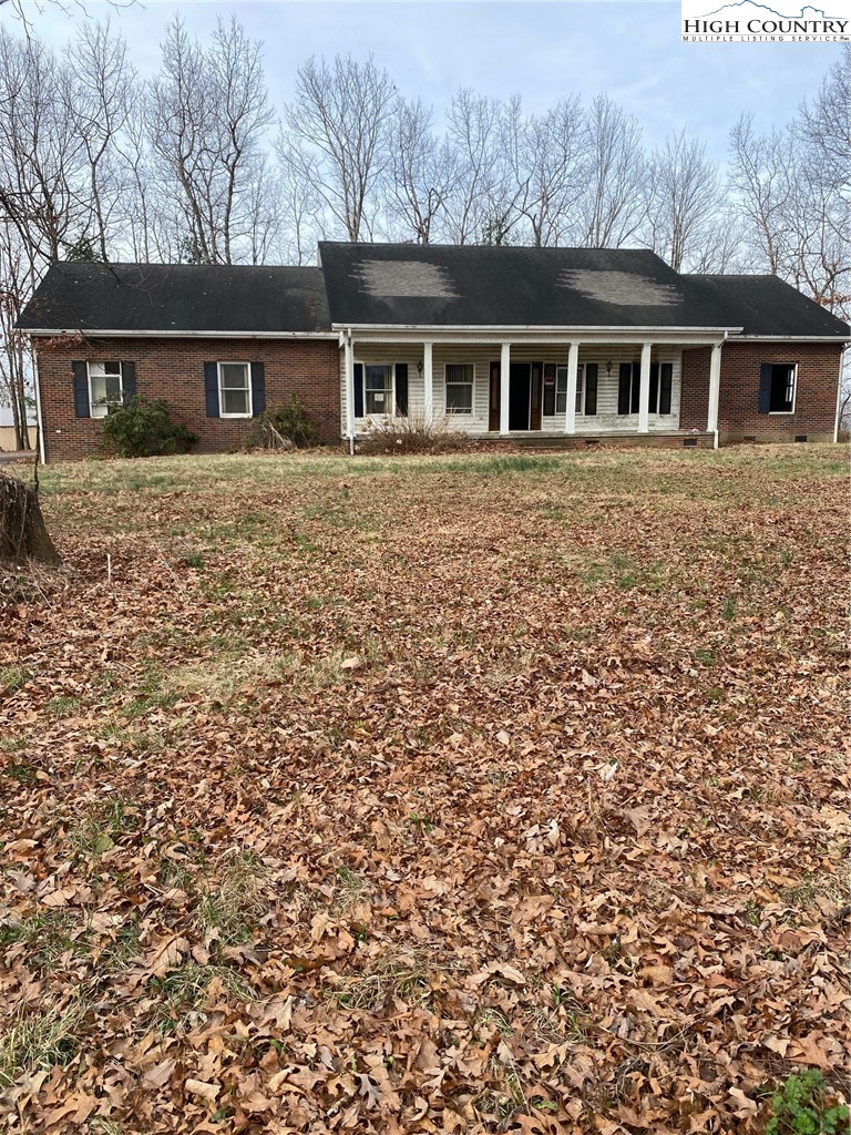 48 Saddle Mountain Church Road Ennice, NC 28623 - Photo 2 of 24 a front view of a house with a garden