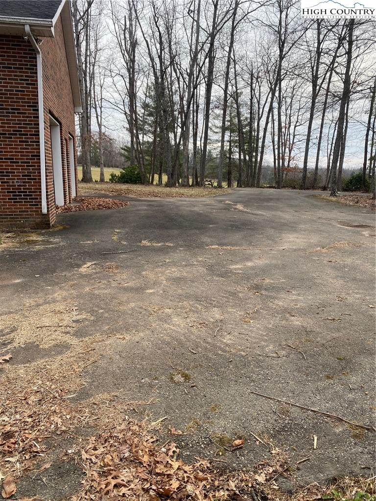 48 Saddle Mountain Church Road Ennice, NC 28623 - Photo 6 of 24 a backyard of a house with trees