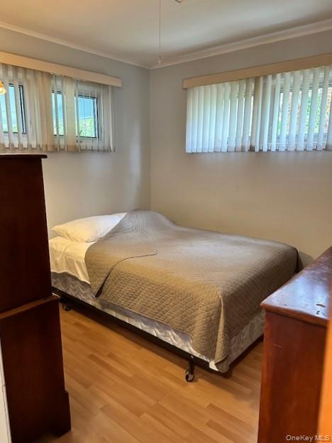 4 Oakhurst Road Hampton Bays, NY 11946 - Photo 5 of 13 Bedroom with ornamental molding and wood finished floors