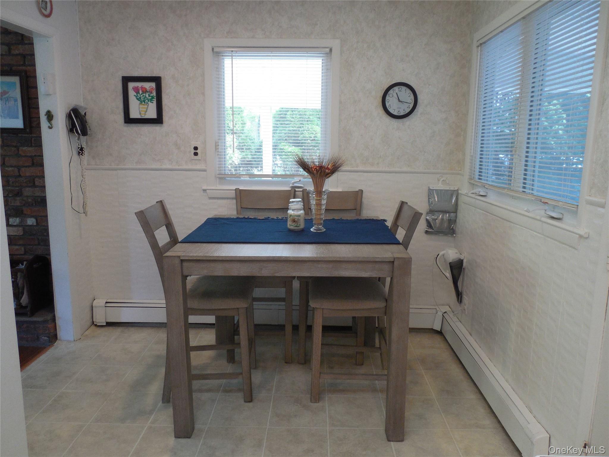 4 Oakhurst Road Hampton Bays, NY 11946 - Photo 7 of 13 Dining room with baseboard heating and wallpapered walls
