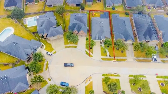 an aerial view of a house with swimming pool