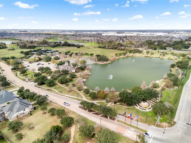 an aerial view of lake and residential houses with outdoor space