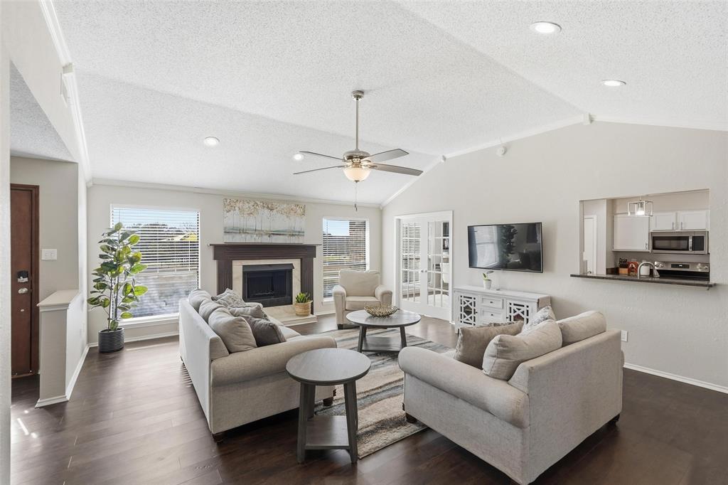 a living room with furniture a fireplace and a flat screen tv