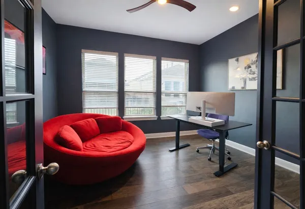 a living room with furniture a rug and a large window