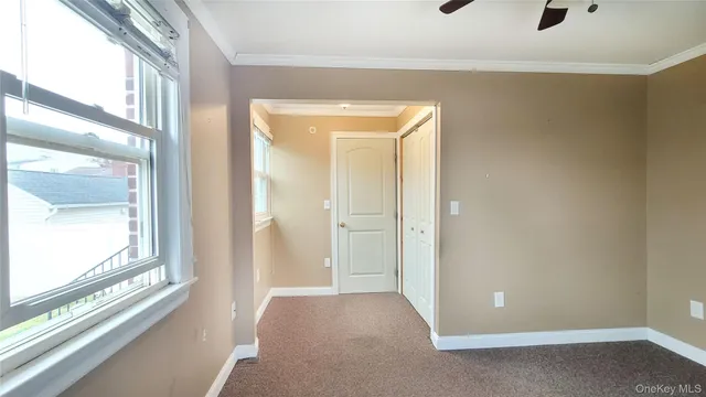a view of a small space with wooden floor and windows
