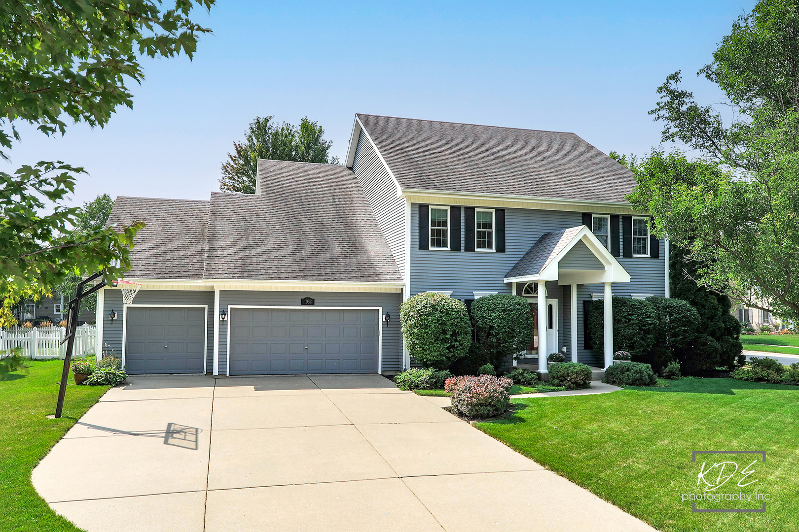 1032 Hamlet Road Naperville, IL 60564 - Photo 1 of 38 a front view of a house with a yard and trees