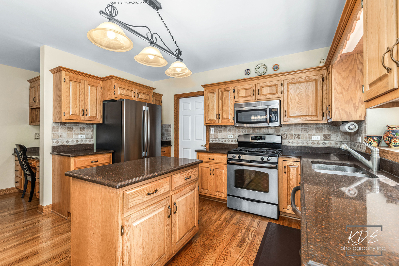 1032 Hamlet Road Naperville, IL 60564 - Photo 12 of 38 a kitchen with stainless steel appliances granite countertop a stove a refrigerator and a microwave