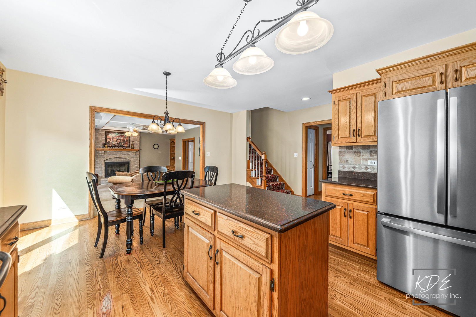 1032 Hamlet Road Naperville, IL 60564 - Photo 13 of 38 a kitchen with stainless steel appliances granite countertop a refrigerator a stove and a dining table with wooden floor