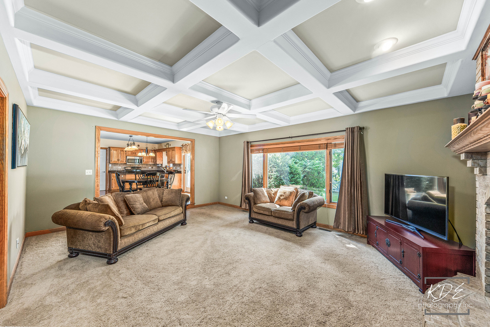 1032 Hamlet Road Naperville, IL 60564 - Photo 19 of 38 a living room with furniture a flat screen tv and a floor to ceiling window