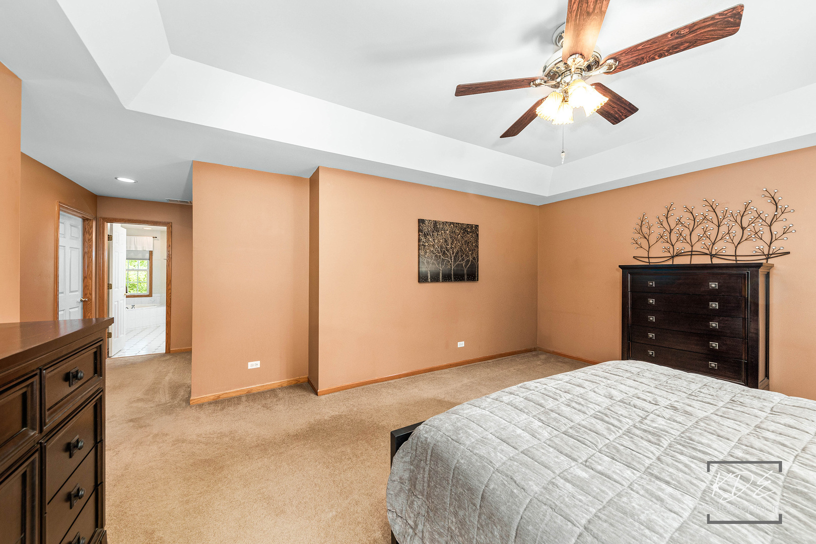 1032 Hamlet Road Naperville, IL 60564 - Photo 23 of 38 a bedroom with a large bed and a chandelier