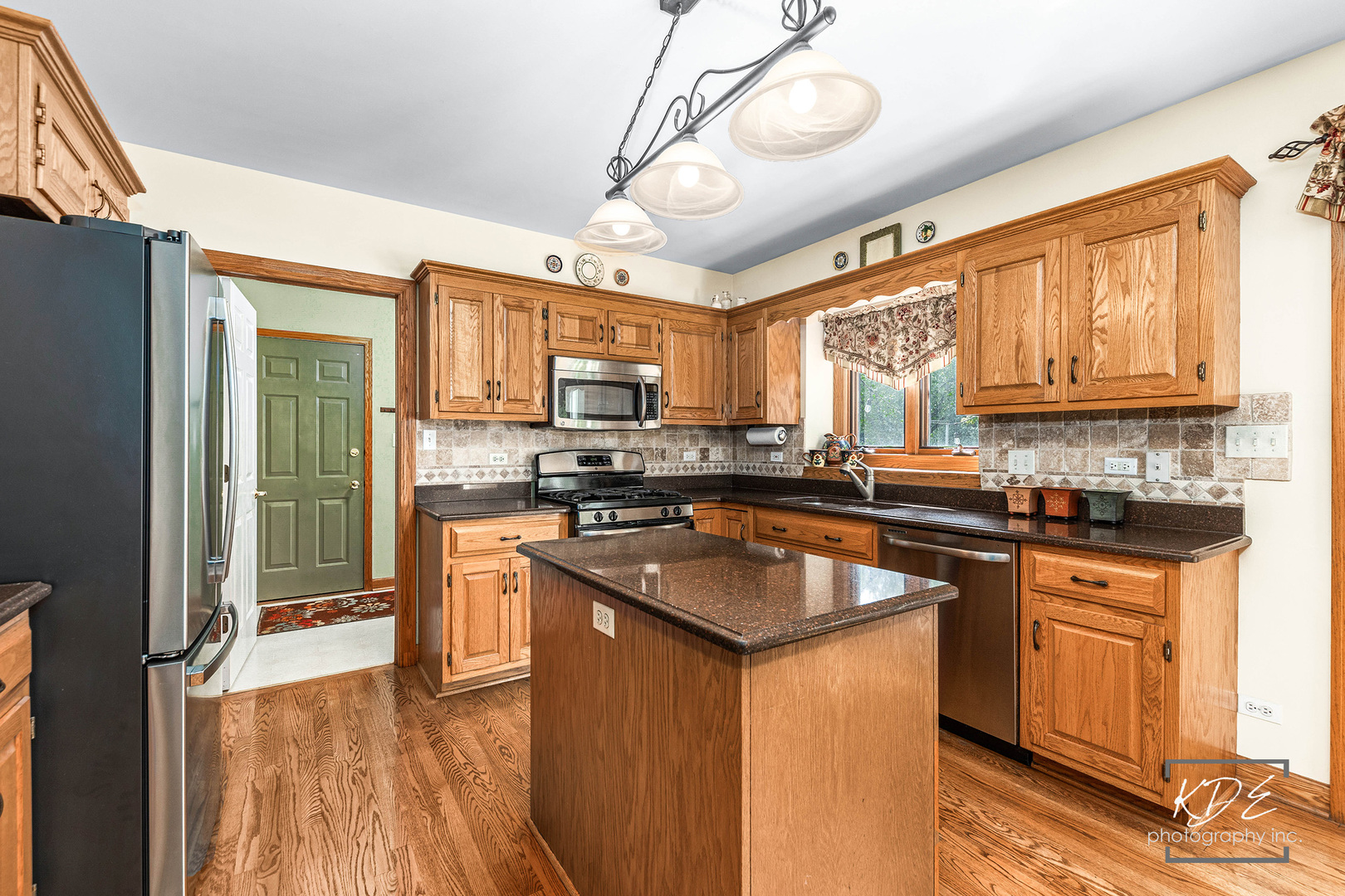 1032 Hamlet Road Naperville, IL 60564 - Photo 10 of 38 a kitchen with stainless steel appliances granite countertop a sink a stove cabinets counter space and a window