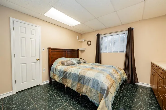 a dining room with furniture water view and a floor to ceiling window