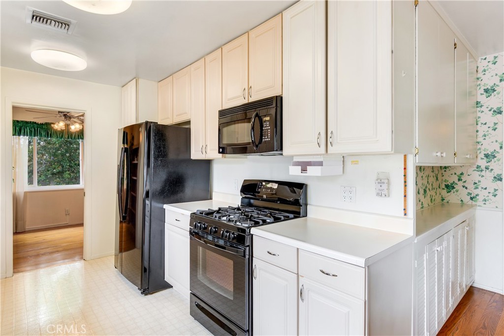 6765 Montclair Drive Riverside, CA 92504 - Photo 11 of 30 a kitchen with a refrigerator stove and microwave