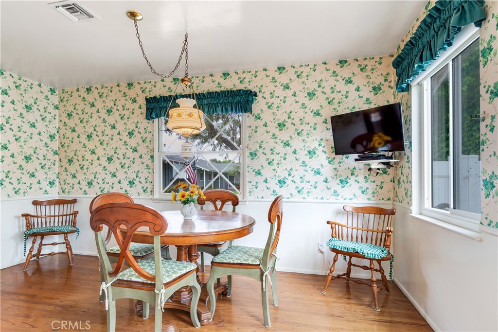 6765 Montclair Drive Riverside, CA 92504 - Photo 14 of 30 a dining room with furniture wooden floor and a flat screen tv