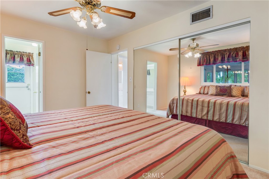 6765 Montclair Drive Riverside, CA 92504 - Photo 16 of 30 a bedroom with a bed and a chandelier