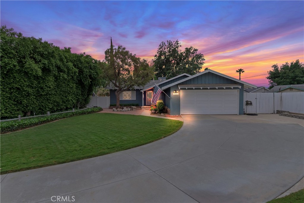 6765 Montclair Drive Riverside, CA 92504 - Photo 2 of 30 a front view of a house with a garden and yard