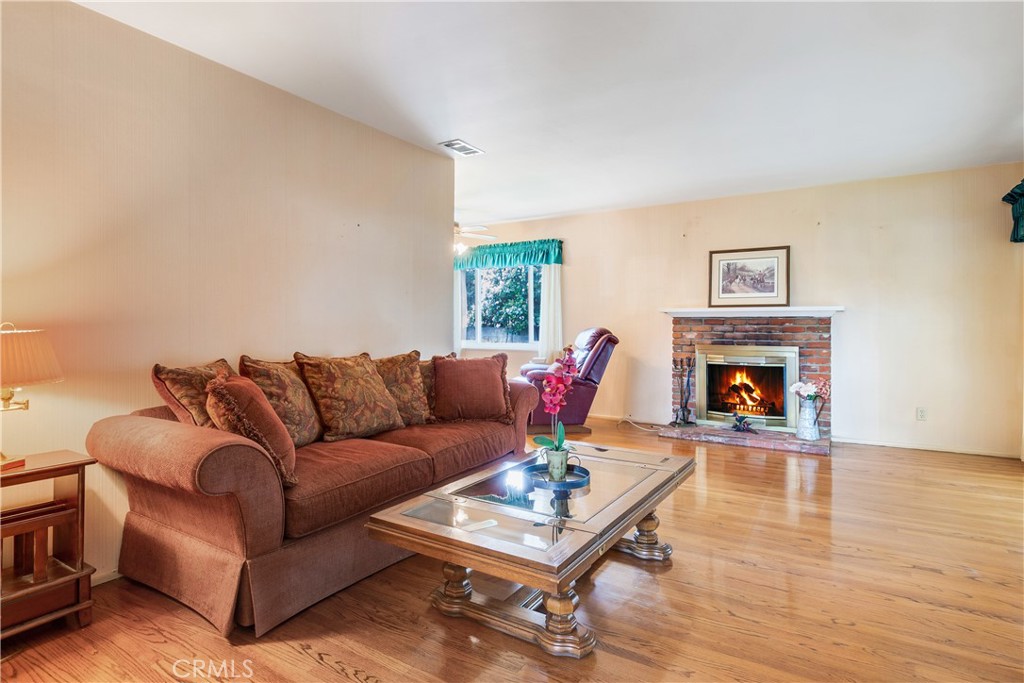 6765 Montclair Drive Riverside, CA 92504 - Photo 6 of 30 a living room with furniture and a fireplace