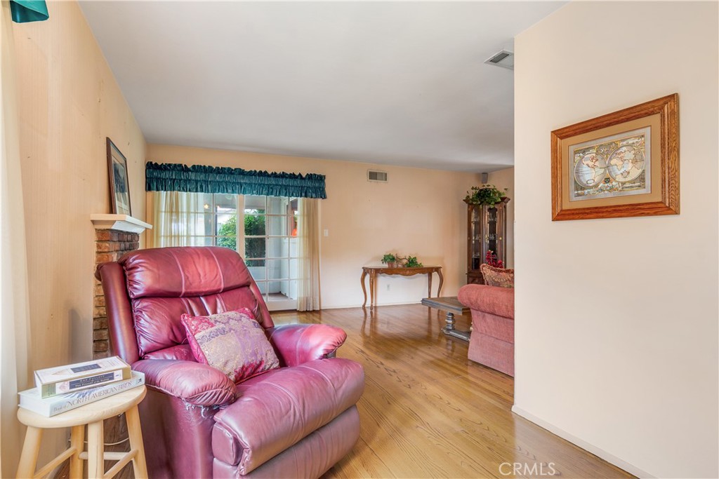 6765 Montclair Drive Riverside, CA 92504 - Photo 9 of 30 a living room with furniture and a wooden floor