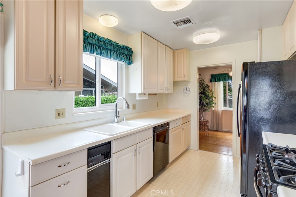 6765 Montclair Drive Riverside, CA 92504 - Photo 10 of 30 a kitchen with a sink and refrigerator