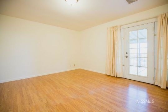 2007 Pickrell Street Ridgecrest, CA 93555 - Photo 17 of 37 an empty room with wooden floor and windows