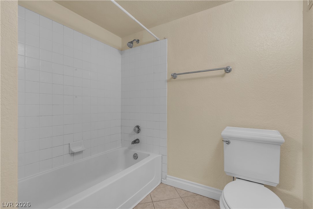8101 West Flamingo Road, Unit 2001 Las Vegas, NV 89147 - Photo 26 of 28 Functional bathroom featuring a tub and shower combination with classic tile surround.