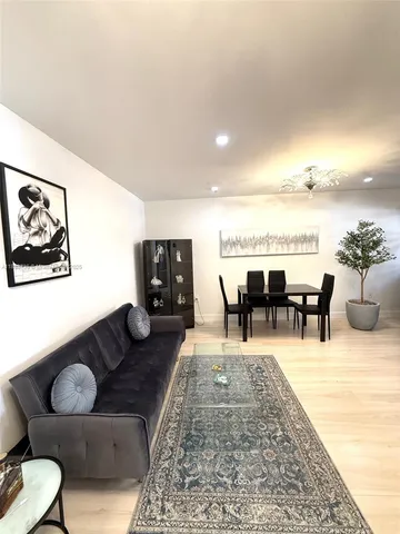 a view of a livingroom with furniture and a flat screen tv