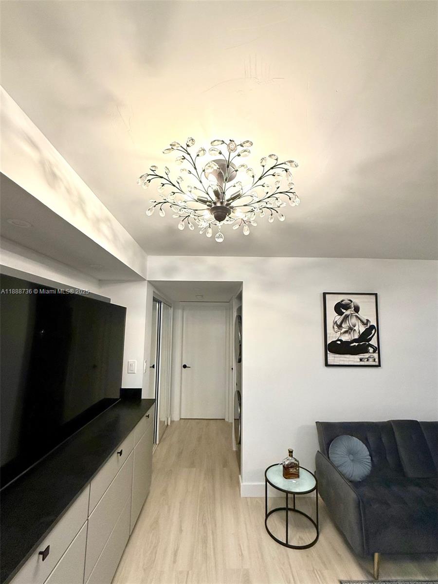 199 Southwest 12th Avenue, Unit 404A Miami, FL 33130 - Photo 15 of 65 a view of a livingroom with furniture and a flat screen tv