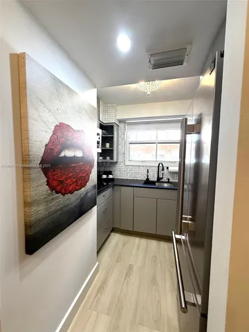 a kitchen with a sink a microwave a stove and cabinets