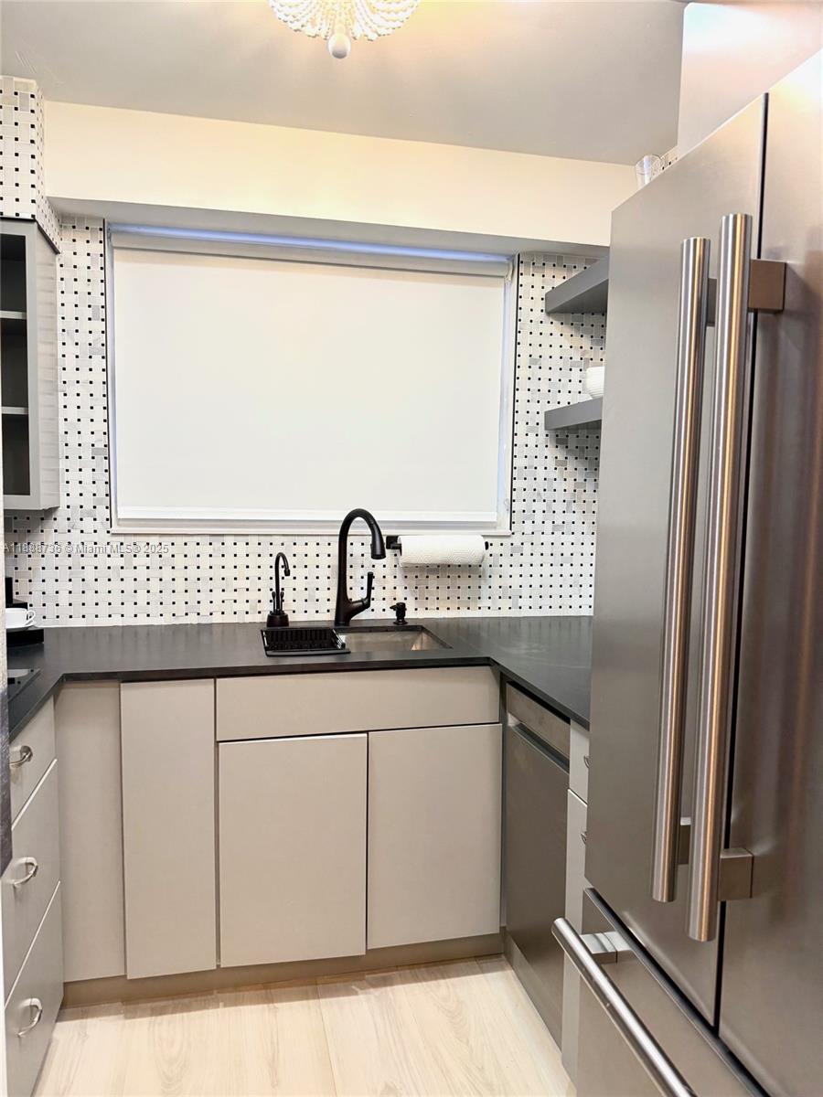 199 Southwest 12th Avenue, Unit 404A Miami, FL 33130 - Photo 21 of 65 a kitchen with a sink and a refrigerator