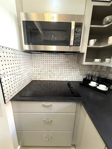 a view of livingroom and kitchen countertops with wooden floor