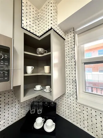a view of a hallway view with wooden floor and furniture