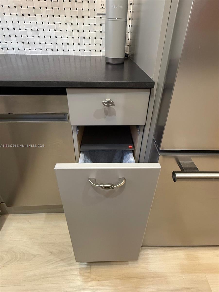 199 Southwest 12th Avenue, Unit 404A Miami, FL 33130 - Photo 28 of 65 a view of livingroom and kitchen countertops with wooden floor