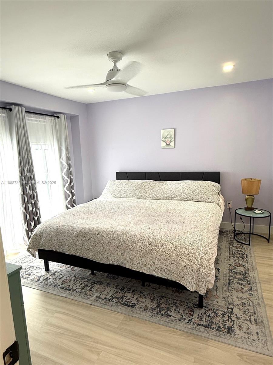 199 Southwest 12th Avenue, Unit 404A Miami, FL 33130 - Photo 37 of 65 a large bed sitting in a bedroom next to a window