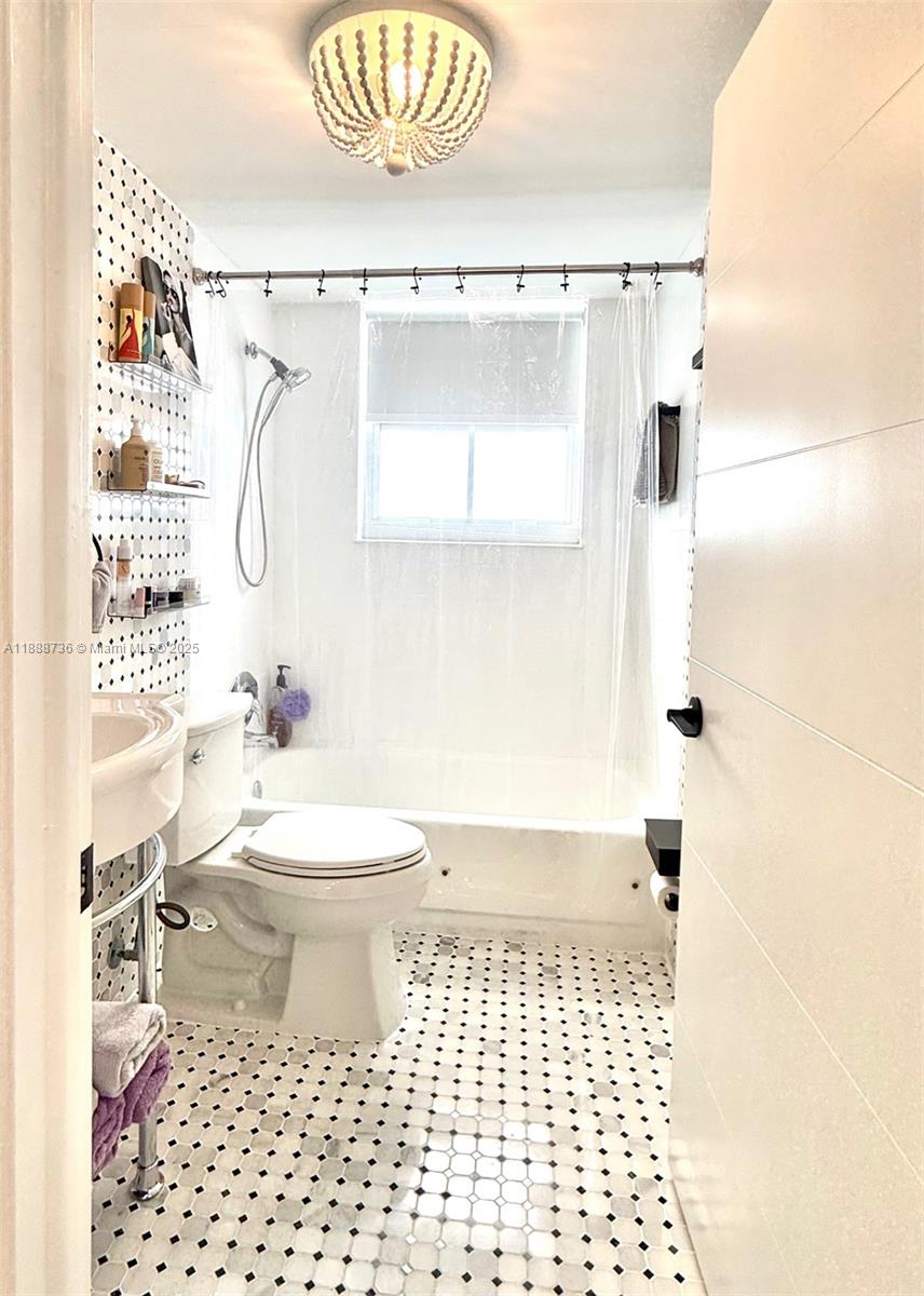 199 Southwest 12th Avenue, Unit 404A Miami, FL 33130 - Photo 8 of 65 a bathroom with a toilet a sink and a shower