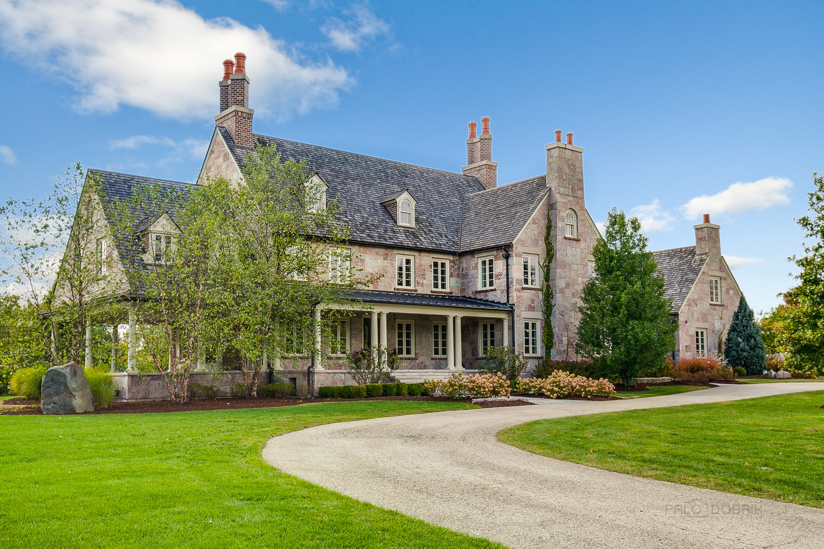 a front view of a house with a garden