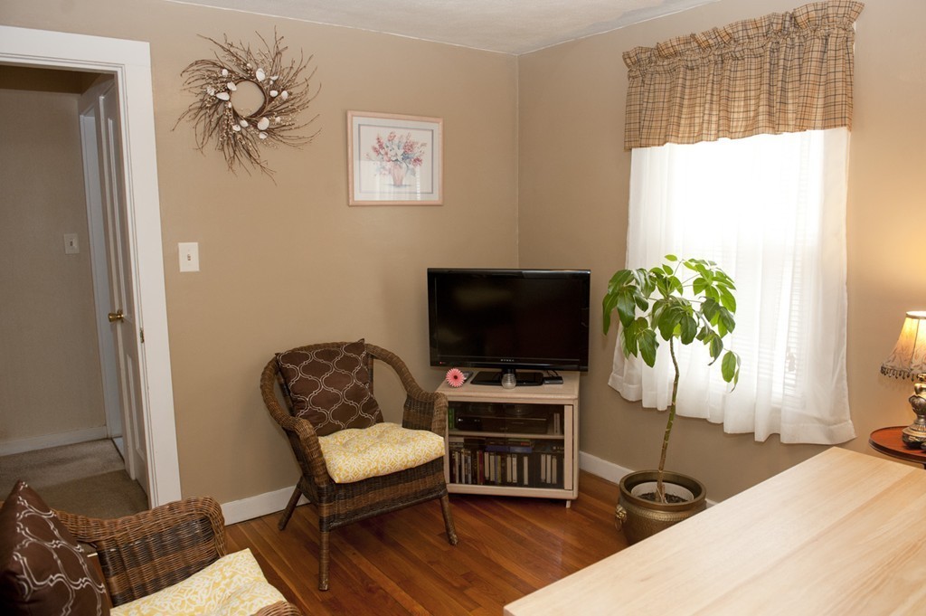 79 Powell Avenue Springfield, MA 01118 - Photo 8 of 20 a living room with furniture and a flat screen tv