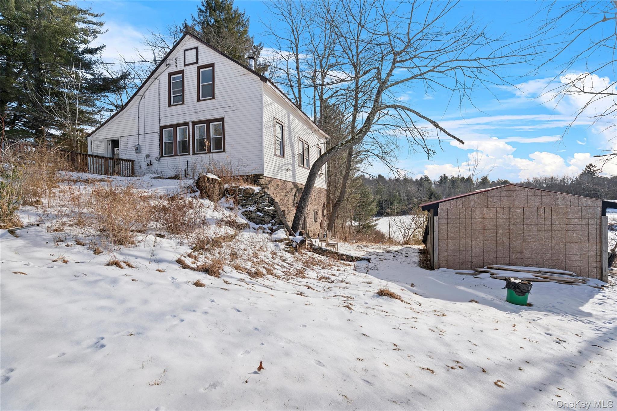 72 Stanton Corner Road, Unit 2 Swan Lake, NY 12783 - Photo 5 of 7 a white house that has a tree in front of it