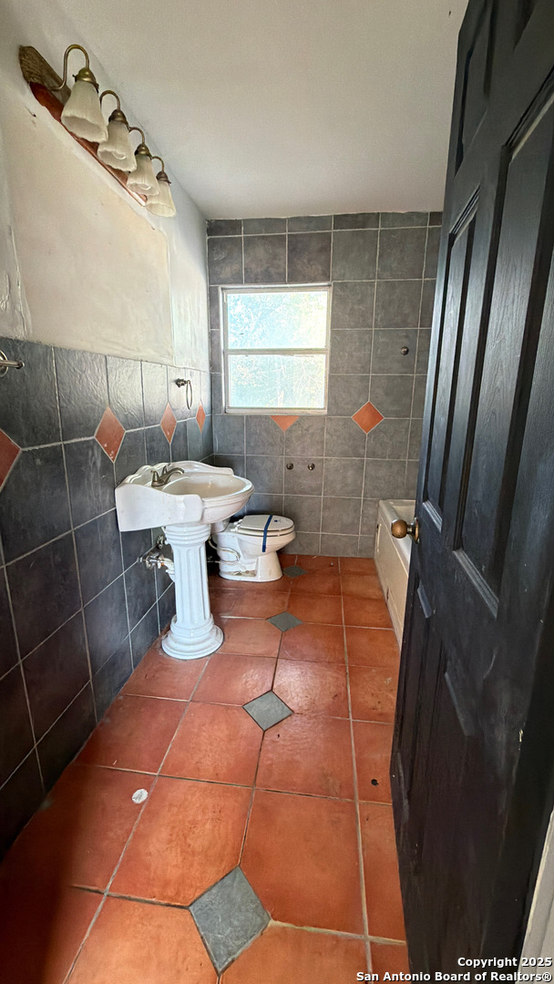 218 Graham Road Kenedy, TX 78119 - Photo 12 of 19 a bathroom with a sink toilet and shower