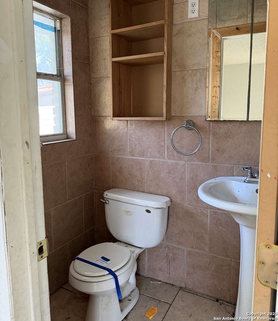 218 Graham Road Kenedy, TX 78119 - Photo 16 of 19 a bathroom with a toilet a sink and mirror