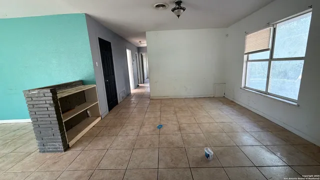 a kitchen with granite countertop a sink a stove a refrigerator and cabinets