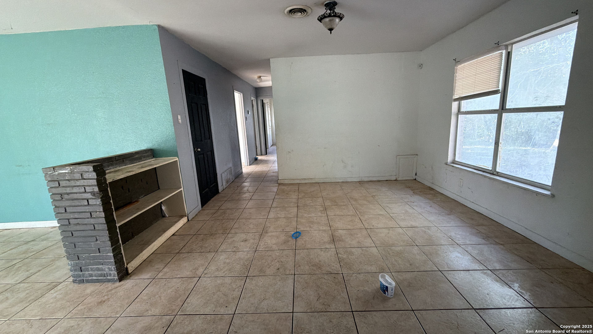 218 Graham Road Kenedy, TX 78119 - Photo 8 of 19 a view of an empty room with a fireplace and a window
