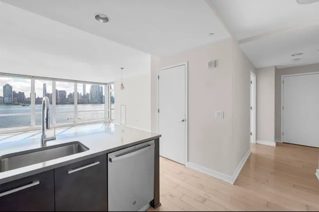 a view of a sink and a large mirror