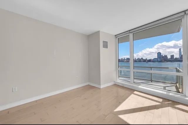 a view of a room with wooden floor