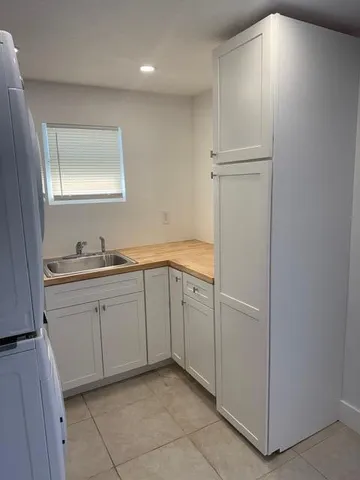 a room with white cabinets and white appliances