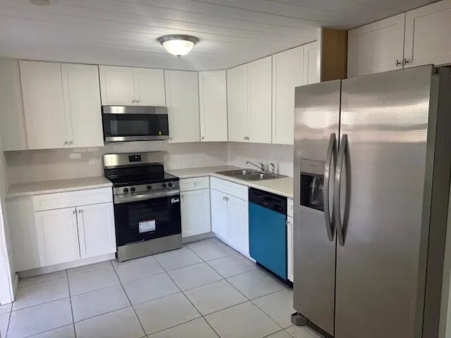 a kitchen with a refrigerator stove and microwave