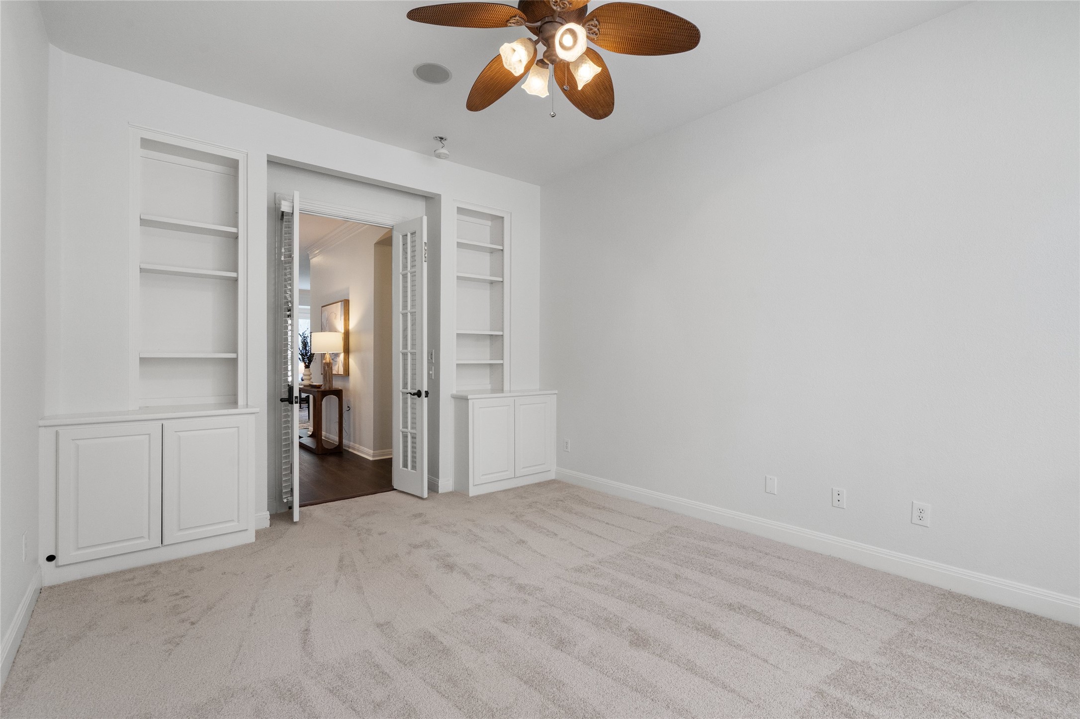 4313 Rio Robles Drive Austin, TX 78746 - Photo 27 of 40 Built-in shelving and French doors elevate this versatile room, perfect for an office or den.