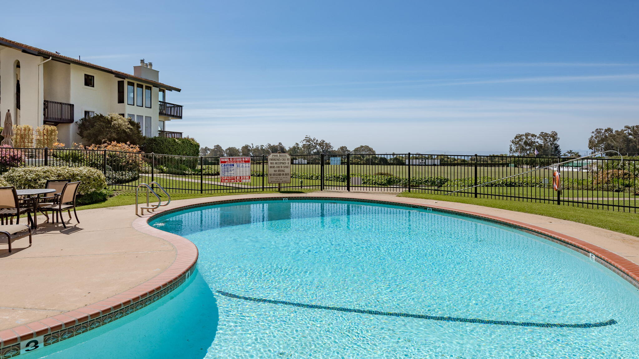 3375 Foothill Road, Unit 233 Carpinteria, CA 93013 - Photo 20 of 21 a view of a swimming pool with a lounge chairs