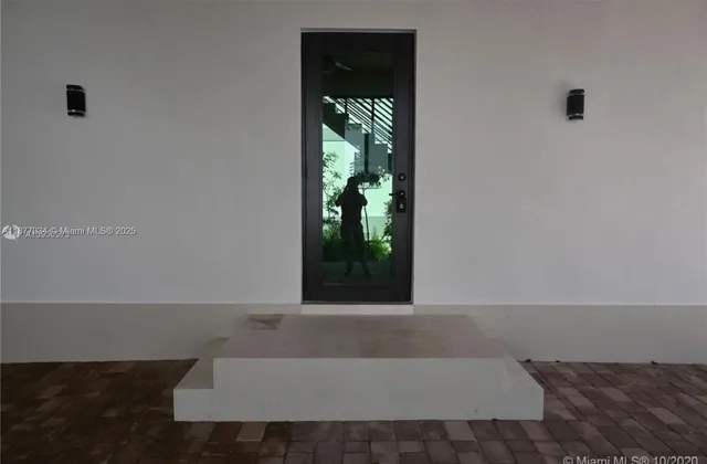 a living room with a window and a fireplace