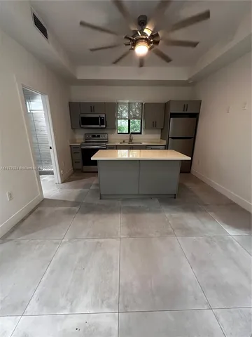 a view of living room with furniture and a ceiling fan