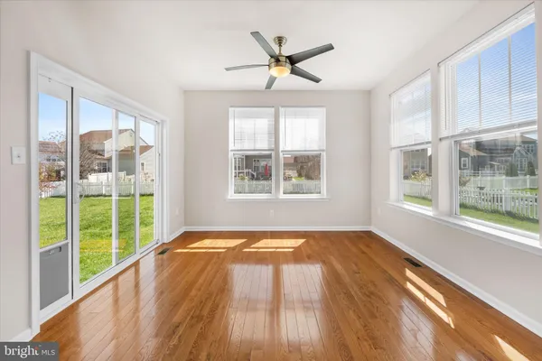 a view of a livingroom with wooden floor and a window